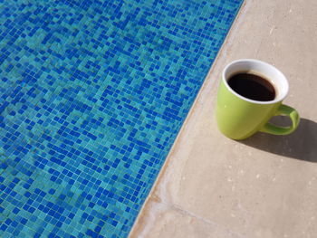 High angle view of coffee cup in swimming pool