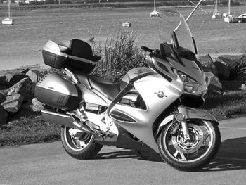 Side view of motor scooter parked on road