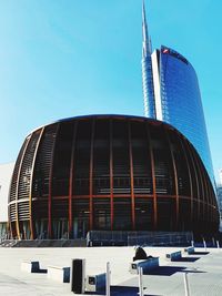 Low angle view of modern building against clear blue sky