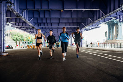 People running on road in city