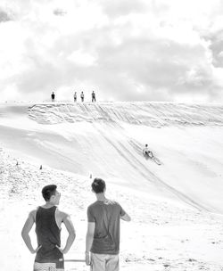 Tourists on snow covered mountain