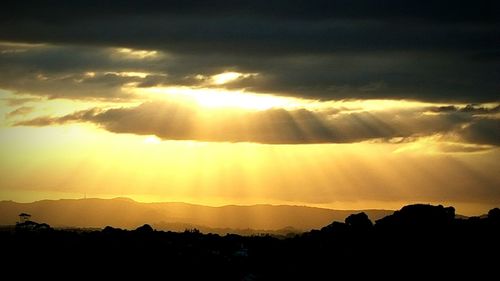 Scenic view of mountains against sky at sunset