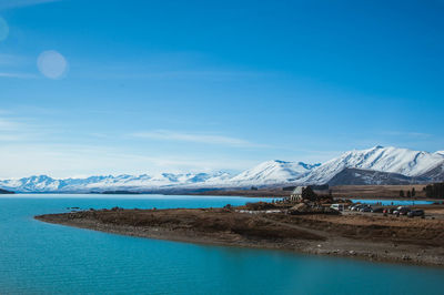 Scenic view of snowcapped mountains against blue sky