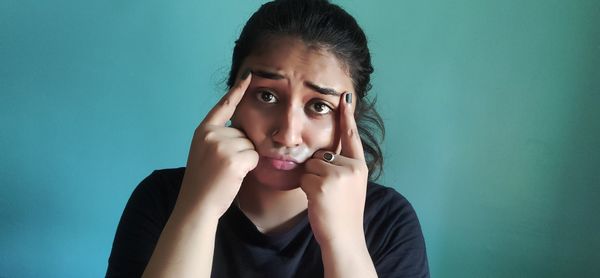 Portrait of girl against wall