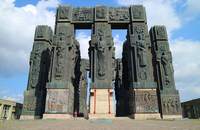 Low angle view of man walking against built structure