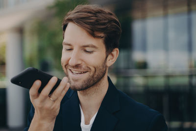 Portrait of young man using mobile phone