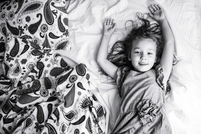 High angle view of girl lying on bed