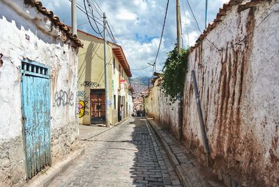 Narrow street amidst buildings against sky