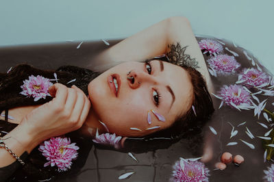 Close-up portrait of woman in bathtub at bathroom