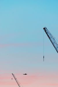 Low angle view of silhouette airplane against sky during sunset