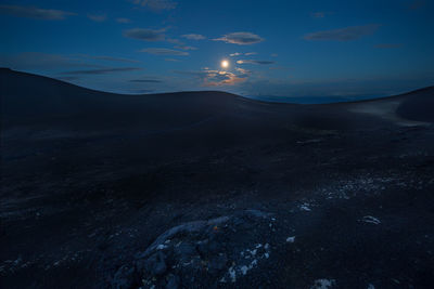 Scenic view of landscape against sky at night