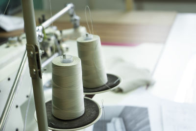 Close-up of a two spools of thread on the industrial sewing machine.