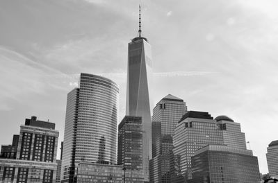 Low angle view of buildings against cloudy sky