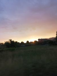 Scenic view of field against sky during sunset