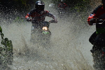 People running on wet road in city