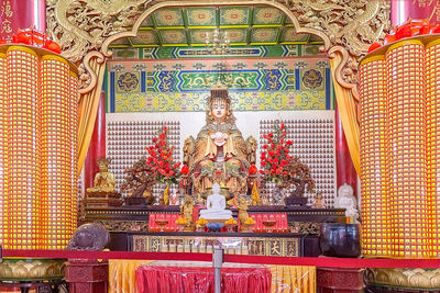 Statue of buddha against building