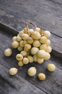 Lansium domesticum, also known as langsat or lanzones on wooden table background