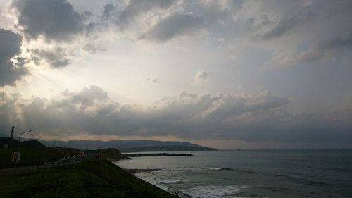 View of beach against cloudy sky