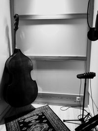 Cello by wall in studio