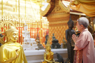 Statue of buddha against building