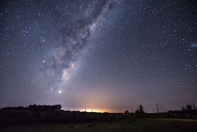 Scenic view of field against sky at night
