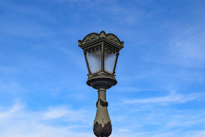 Low angle view of street light against building