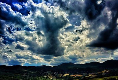 Scenic view of dramatic sky over landscape