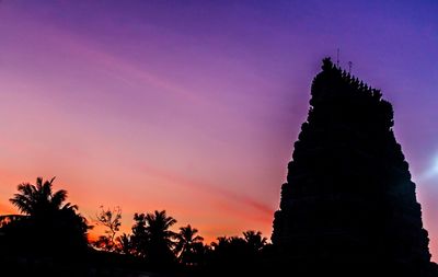 Low angle view of silhouette trees against sky during sunset