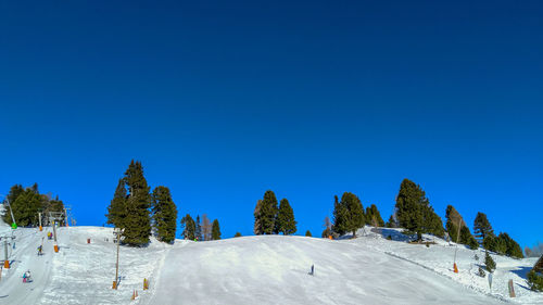 Scenic view of snowcapped mountains against clear blue sky