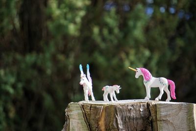 Unicorns perching on wooden post