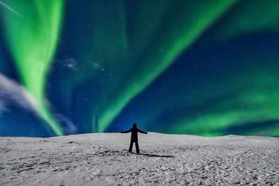 Low angle view of man standing on snow