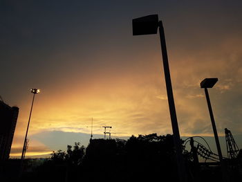 Low angle view of silhouette street light against sky during sunset