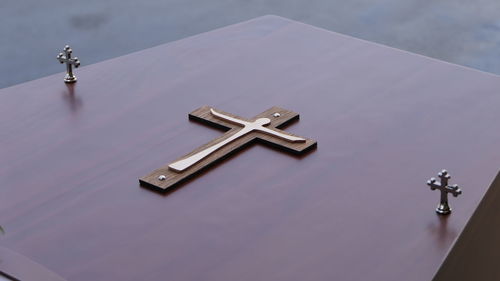 Closeup shot of a funeral casket or coffin in a hearse or chapel or burial at cemetery
