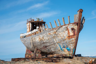 Old rusty ship against blue sky