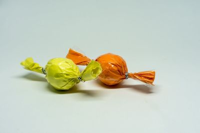 High angle view of multi colored candies on white background