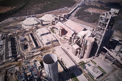 Huge cement producing plant. aerial view of silos towers, pipes and structures of industrial area