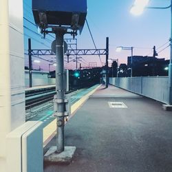 Illuminated street light against sky