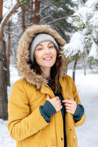 Portrait of a smiling young woman in winter