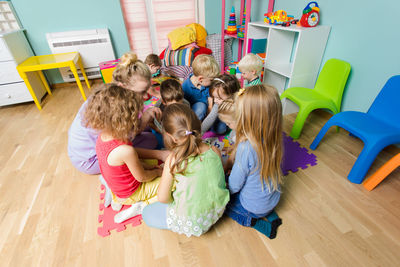 High angle view of kids playing at classroom