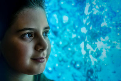 Close-up portrait of woman looking at swimming pool