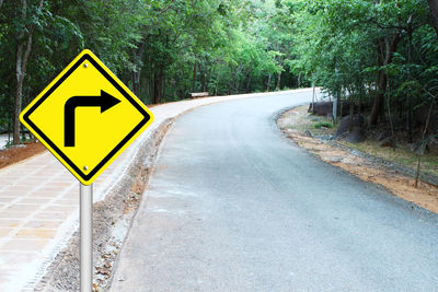 Road sign by trees