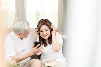 Woman sitting on a man looking away