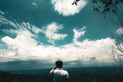 Rear view of man standing against sky