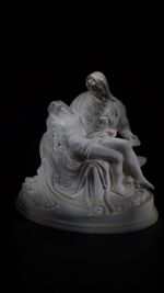 Close-up of statue against black background