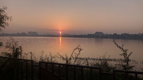Scenic view of lake against sky during sunset