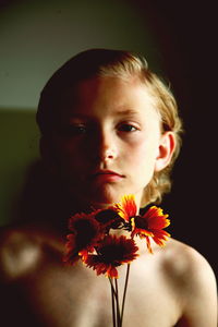 Close-up portrait of young woman with flowers