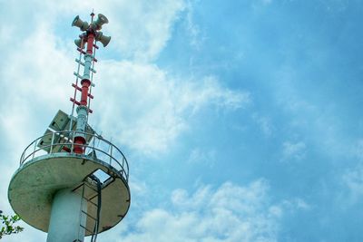 Low angle view of communications tower against sky