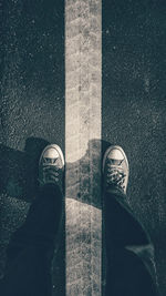 Low section of man standing on street