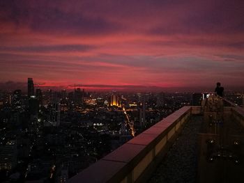 Illuminated cityscape against sky at night