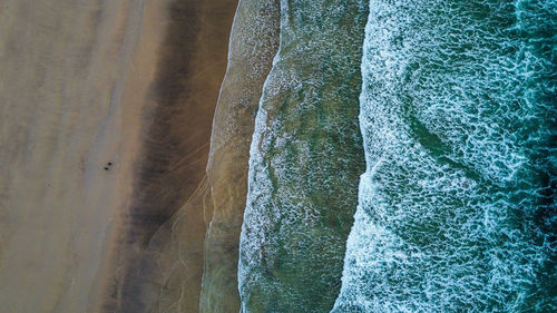 High angle view of surf on beach